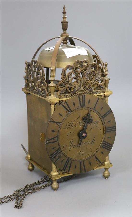 An early 20th century brass lantern clock, by Thos. Moore, Ipswich, with weight and pendulum. height 39cm